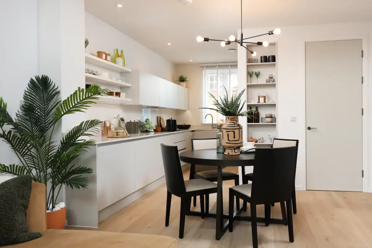 Open-plan kitchen diner with glossy white work tops, ample storage and stylish extras.