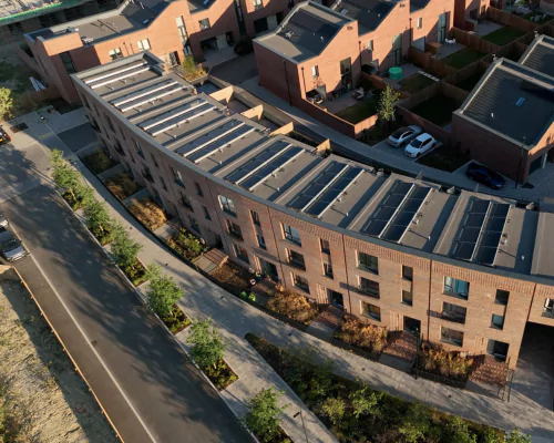 Top-down view of three-storey townhouses with solar panels. 