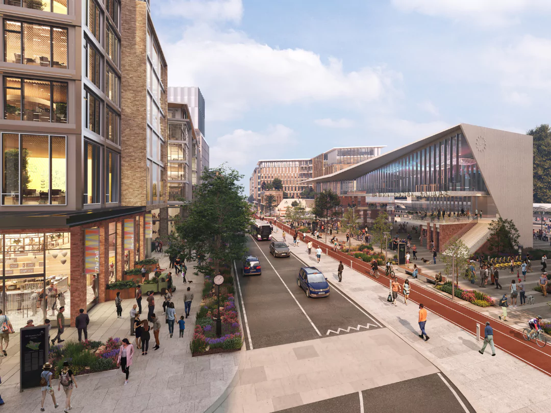 A busy street scene of people walking the tree lined streets outside the train station at Brabazon.