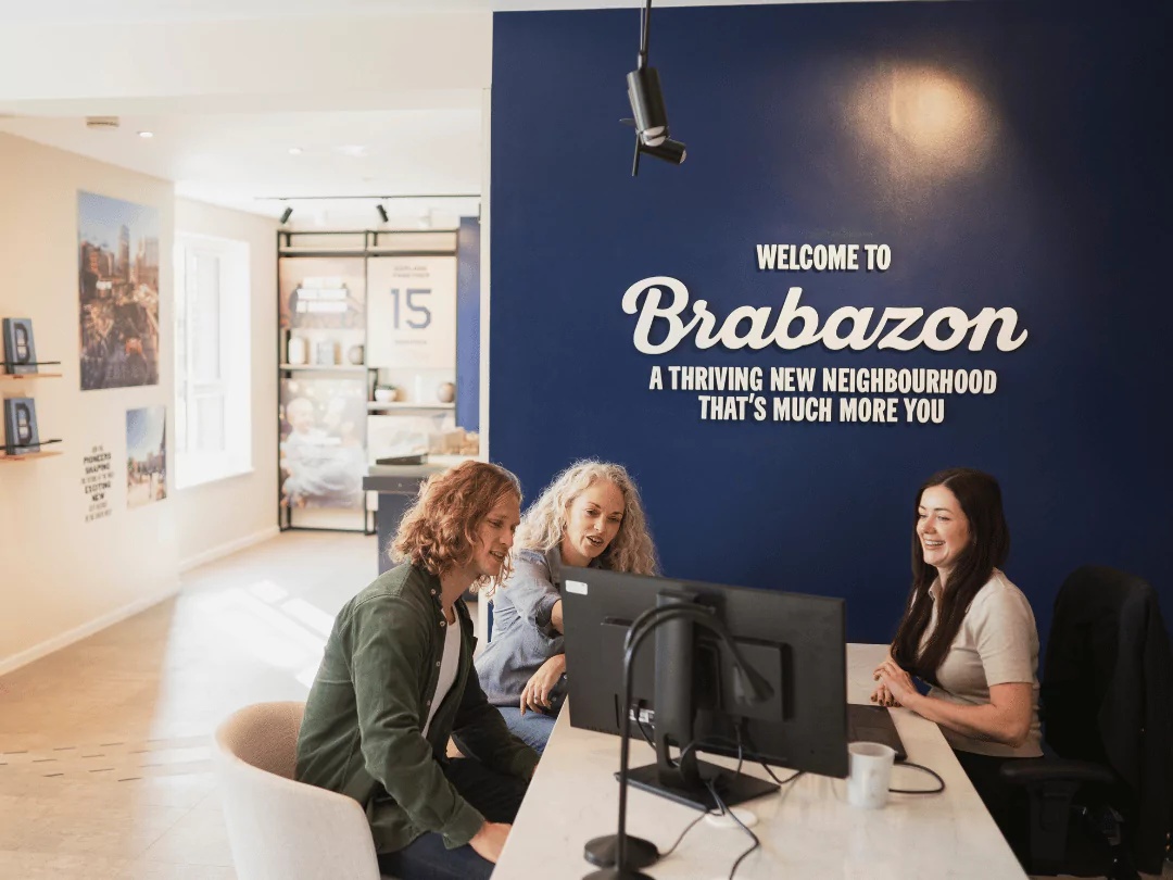 Customers conversing with a New Homes Consultant within the Brabazon Sales Centre.