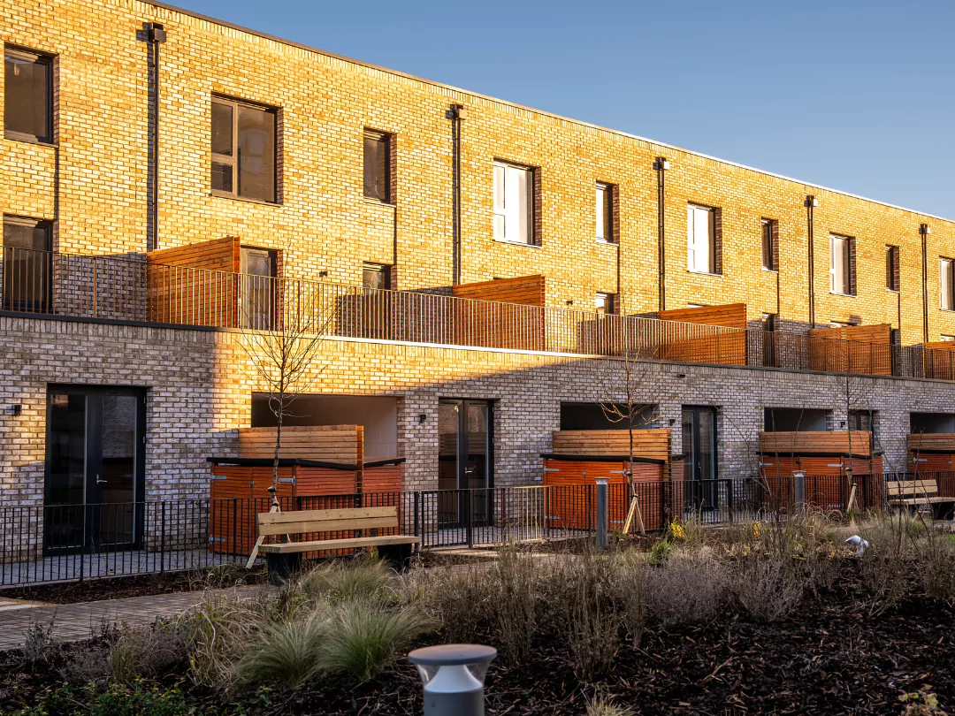 The rear exterior of The Burney three-bedroom townhouses in the sunshine.