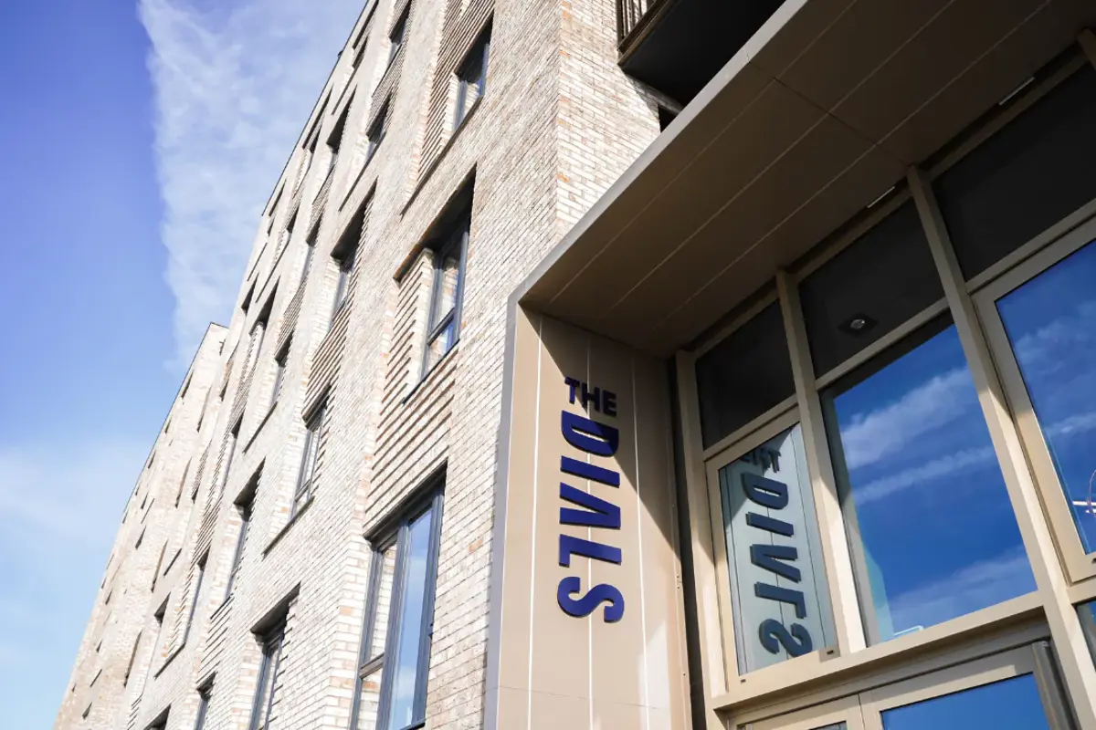 The Dials sign on the front facade of The Dials apartment building.