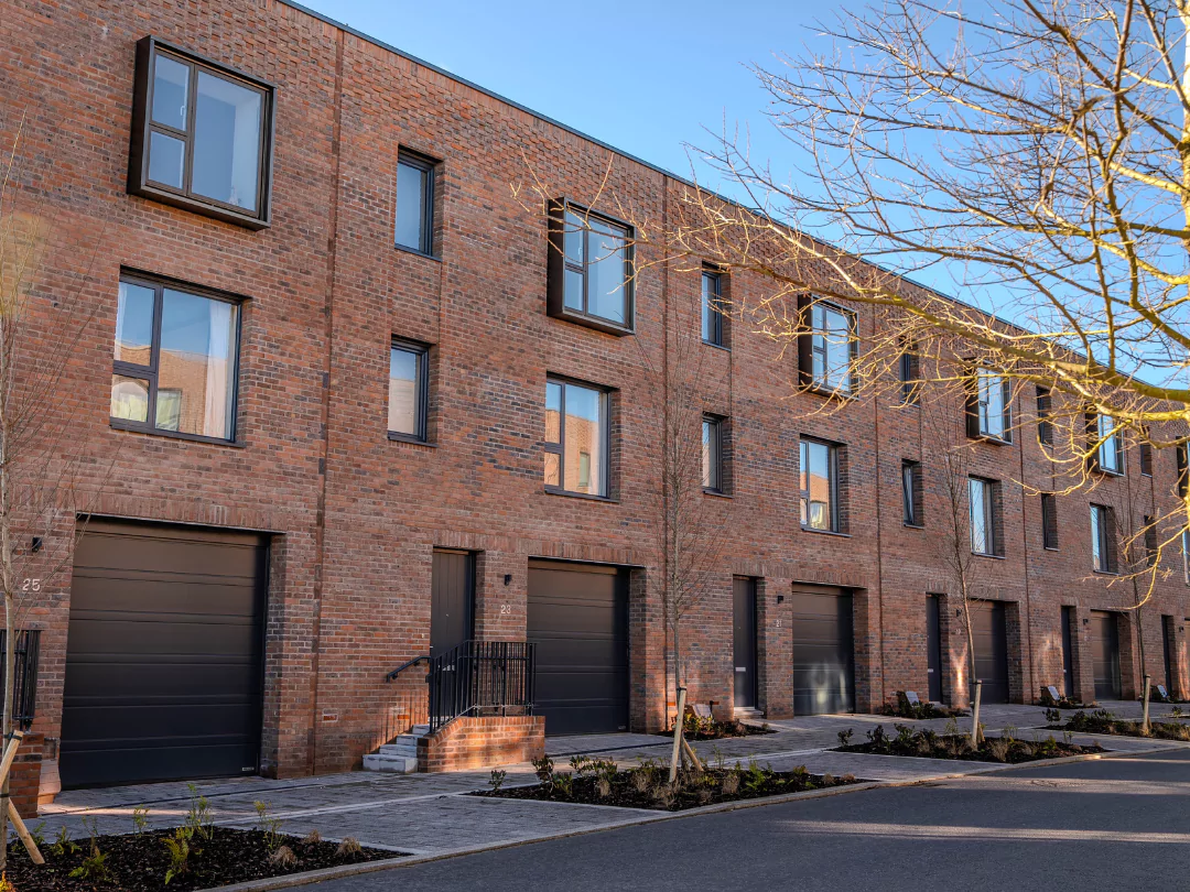 The front exterior of The Burney row of three-bedroom, red-brick terraced townhouses at Brabazon, Bristol.