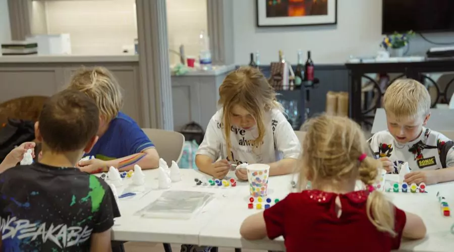 Group of young kids hand painting ceramic gnomes in celebration of Gromit Unleashed 3 coming to Brabazon, Bristol.