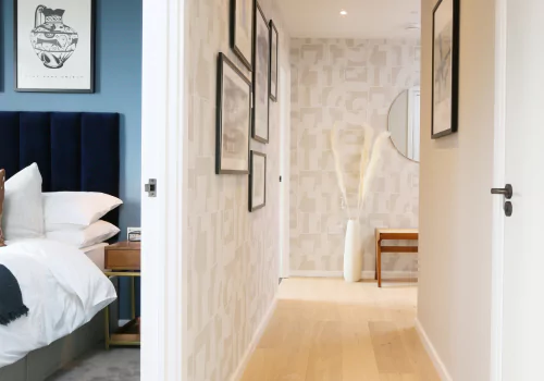 Hallway and bedroom in a modern apartment with light wood flooring.